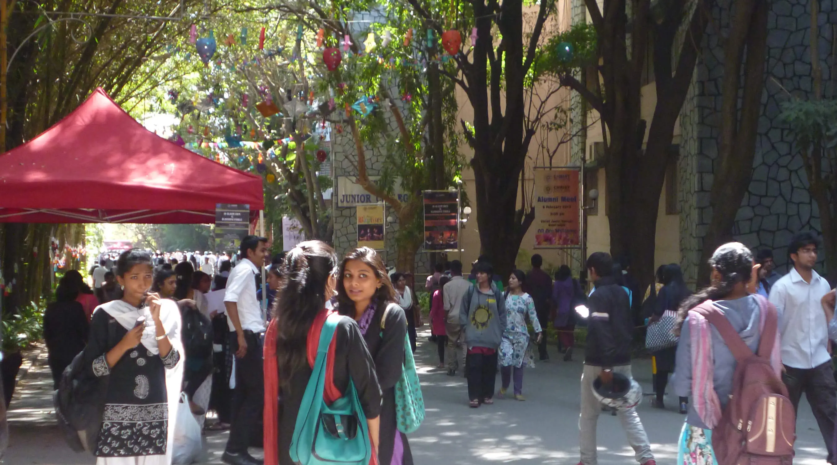 Many people walking on a street in India.