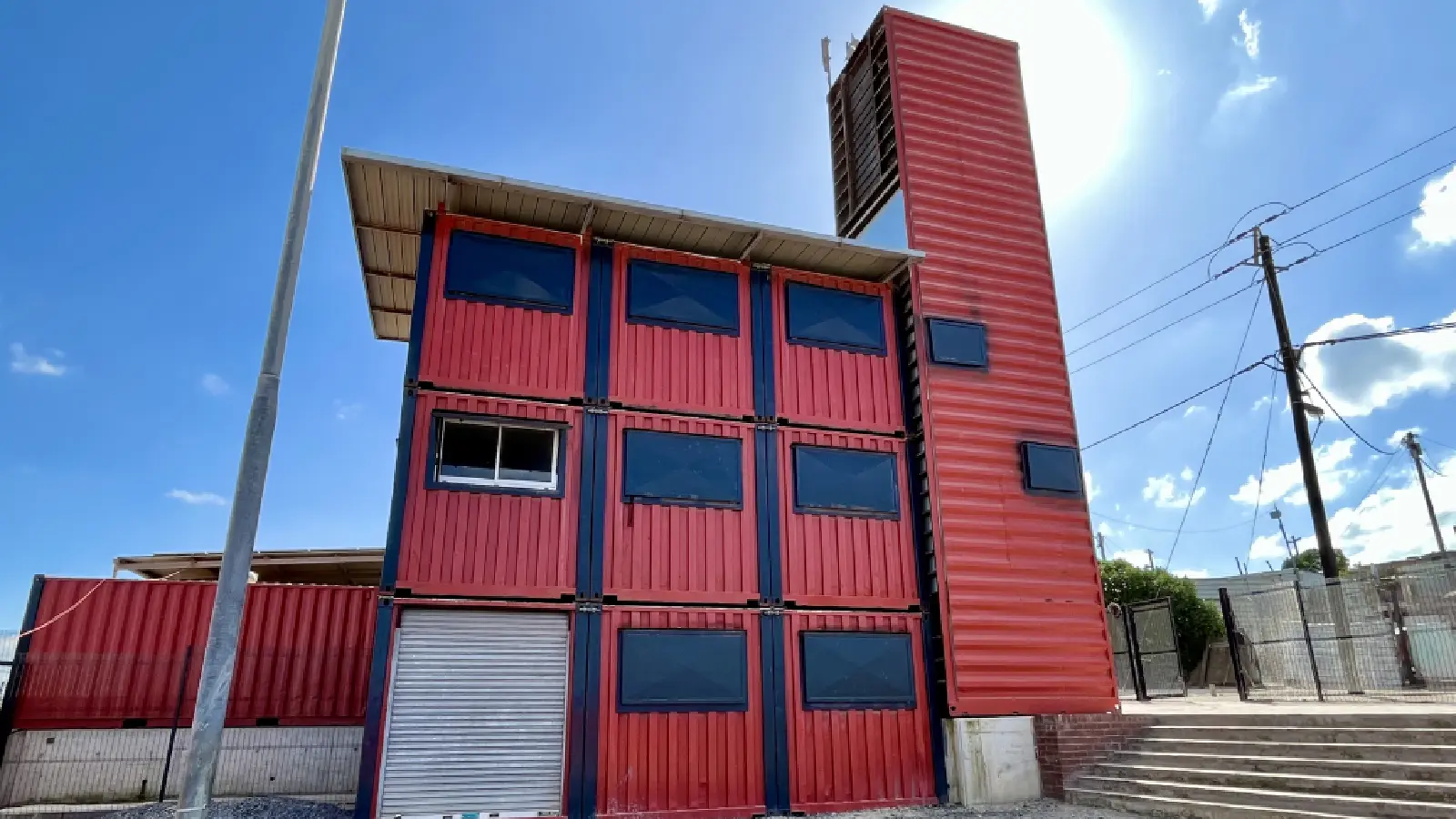 A red, multi-storey container house: Community centre Monwabisi Park in Khayelitsha, Cape Town.